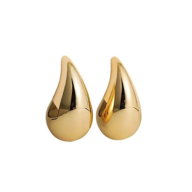 Gold teardrop earrings on a white background