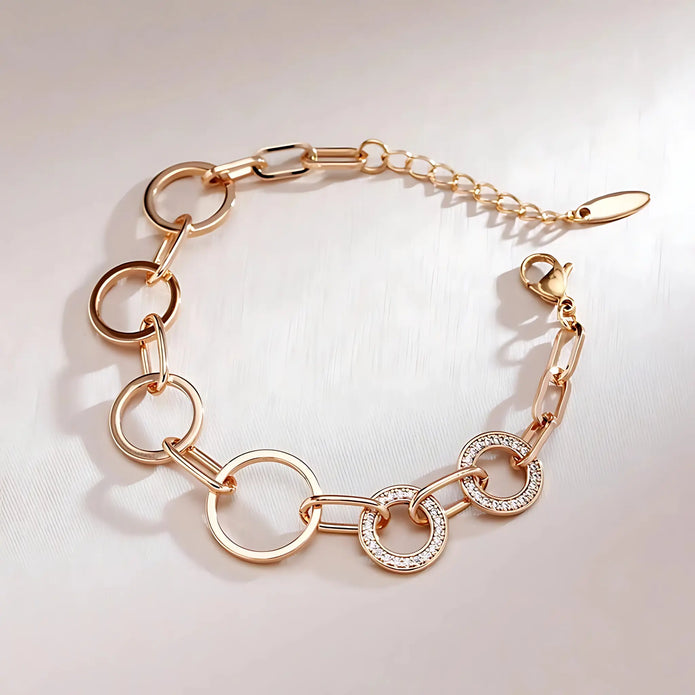 Rose gold bracelet with diamond accents on a light background