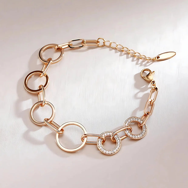 Rose gold bracelet with diamond accents on a light background