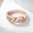 Angled shot of the Rose Gold Crossover Band Ring highlighting its intertwined rose gold bands and elegant zircon details.