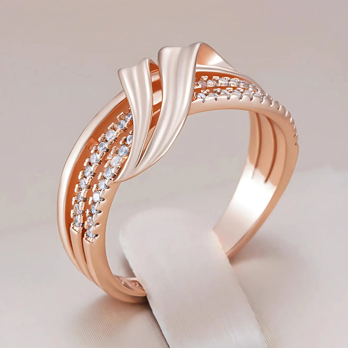 Side view of the Rose Gold Crossover Band Ring featuring a sleek crossover design with sparkling cubic zirconia accents.