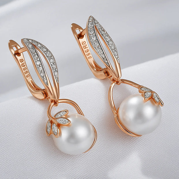 Close-up of rose gold crystal flower pearl drop earrings with cubic zirconia accents and elegant pearl drops.