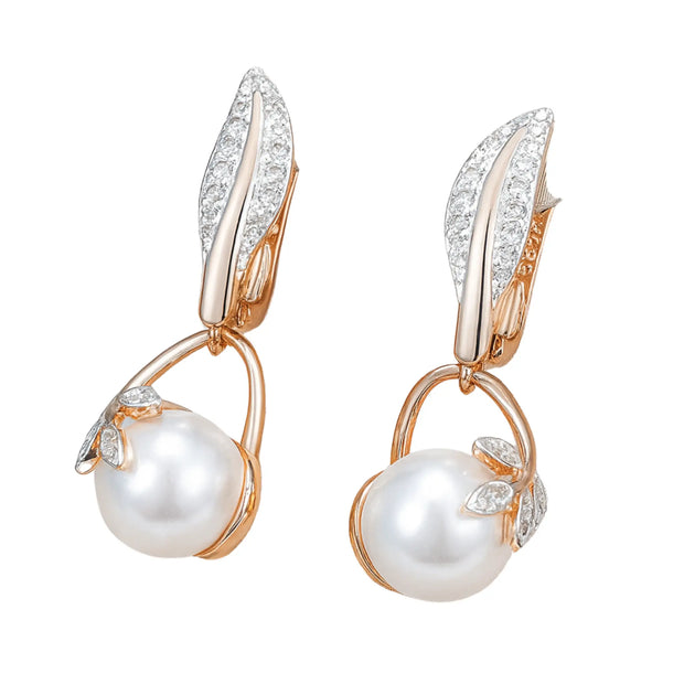 Rose gold crystal flower pearl drop earrings showcased on a jewelry stand, featuring sparkling zircon leaves and round pearls.