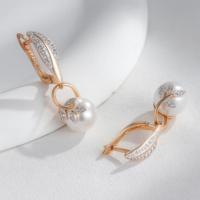 Rose gold crystal flower pearl drop earrings displayed on a white surface, highlighting the floral zircon details and pearl design.