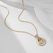 Rose gold pendant necklace displayed flat with a twisted chain on a white surface