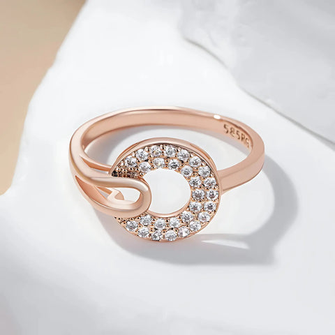 Rose gold ring with diamond accents on a light background