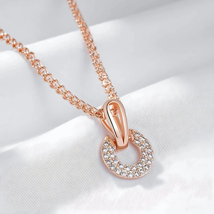 Rose gold necklace with a pendant on a white background