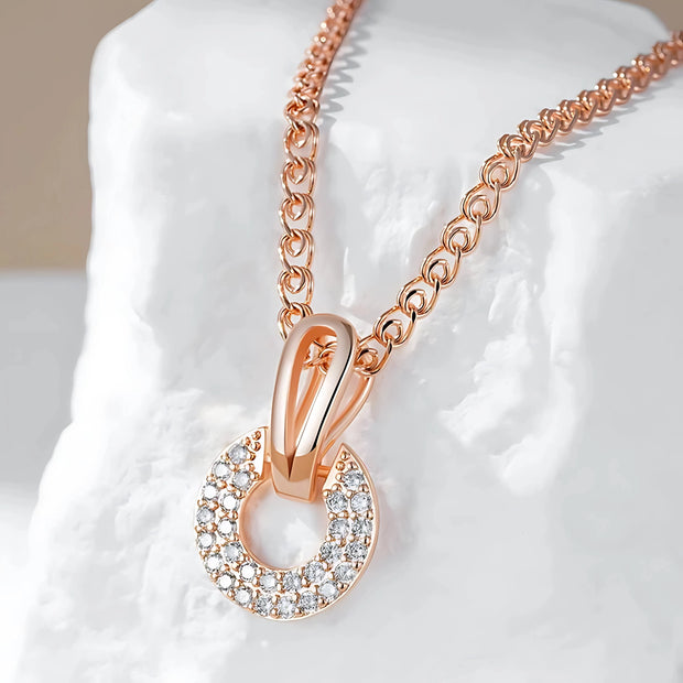 Rose gold necklace with a pendant on a white background