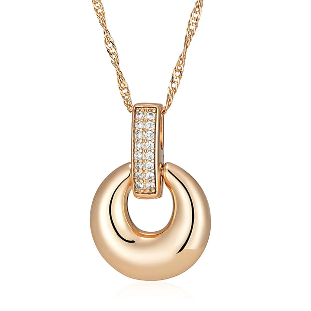 Gold necklace with a circular pendant and diamond accents on a white background