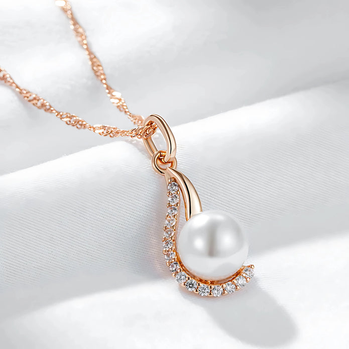 Pearl necklace with rose gold chain on a white background