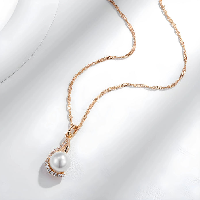 Pearl necklace with rose gold chain on a white background