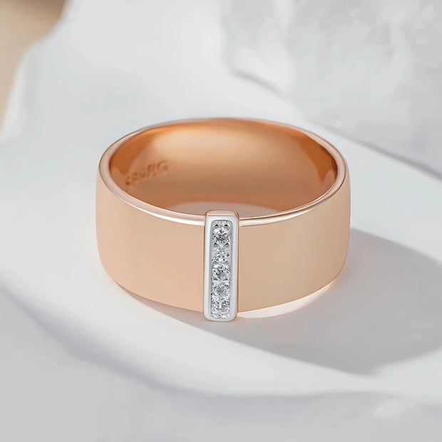 Rose gold ring with diamond accents on a light background